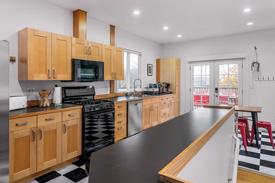 Fully stocked kitchen with numerous barstools for the whole group!