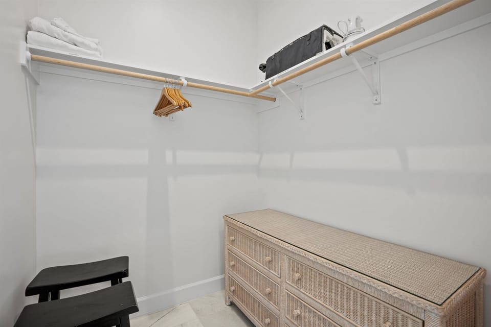 Second bedroom closet with pack n play, highchair, and more children's items