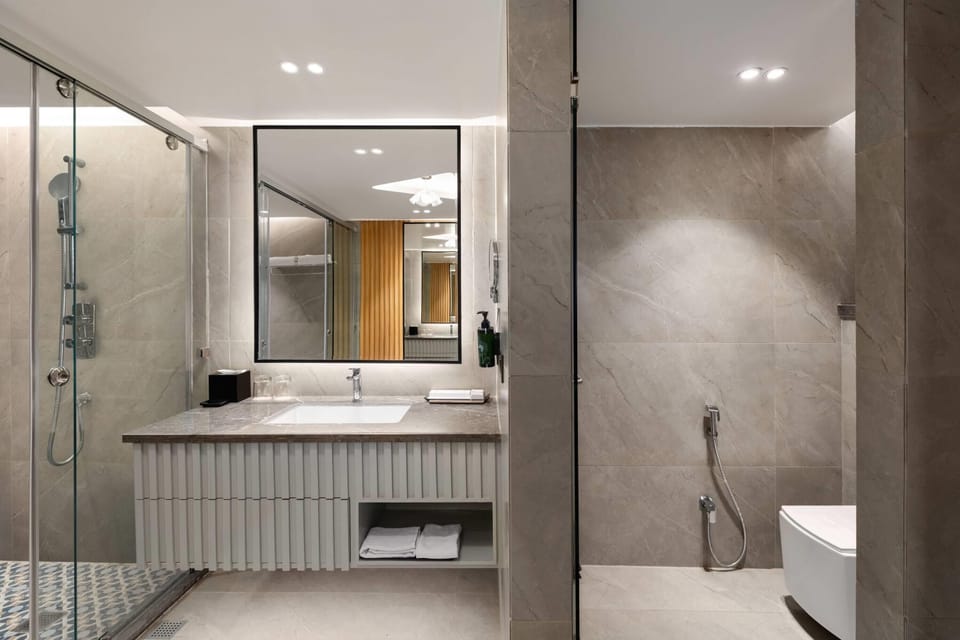 Premium Suite, 1 King Bed, City View | Bathroom | Eco-friendly toiletries, slippers, towels, soap