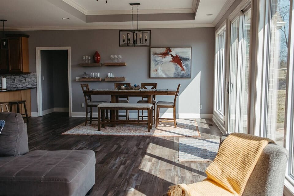 Living room with couch, dining table & glass doors.