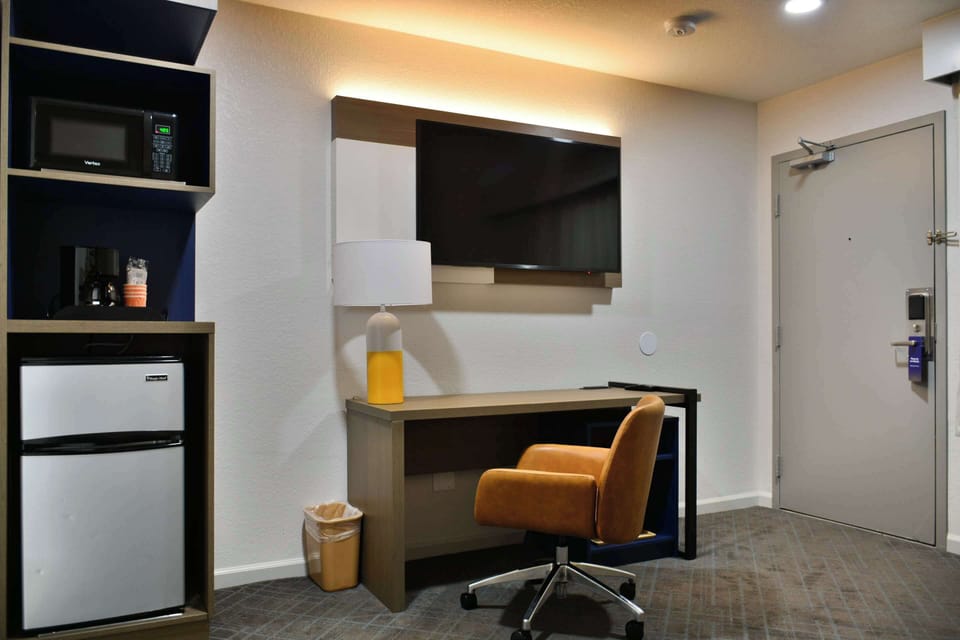 Desk, laptop workspace, blackout drapes, iron/ironing board