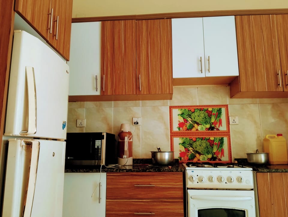 Deluxe Double Room, Balcony, Garden View | Private kitchen | Fridge, microwave, oven, stovetop
