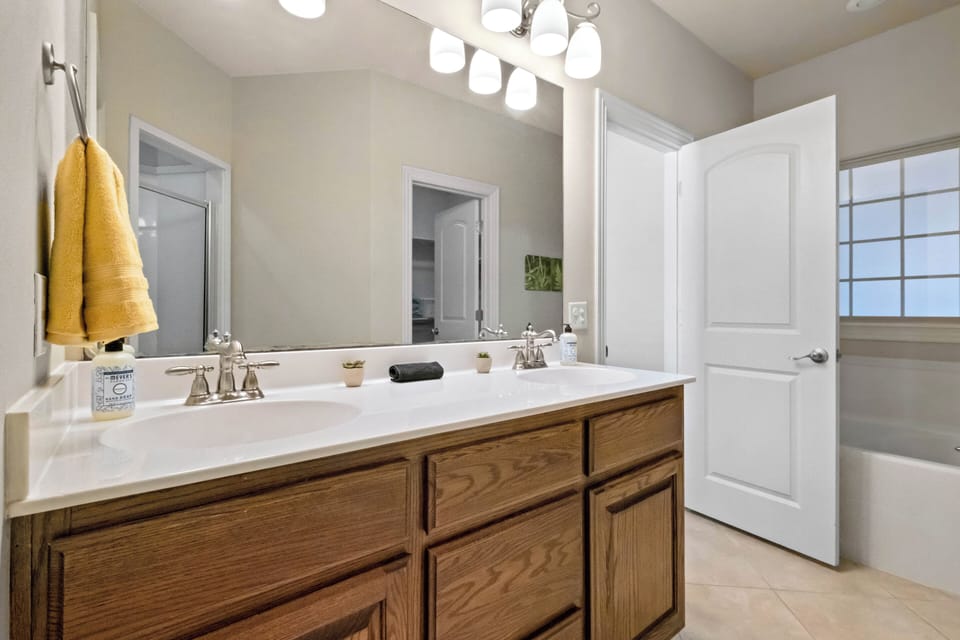 Private en suite primary bathroom with dual sinks, walk in shower & soaking tub!