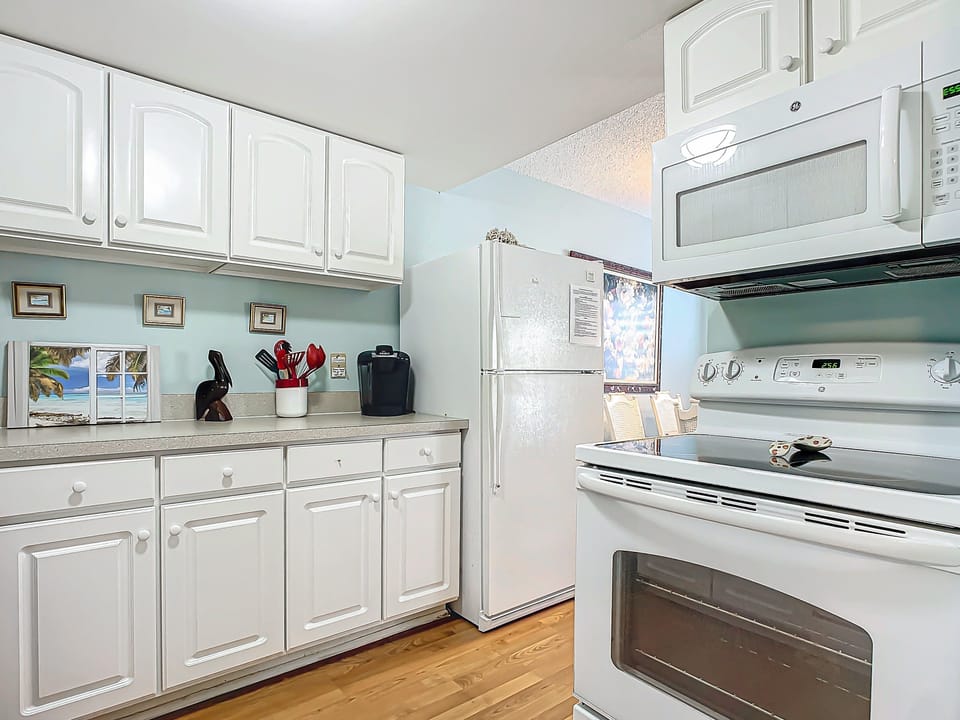 A sleek kitchen featuring modern appliances, perfect for cooking and enjoying homemade meals.
