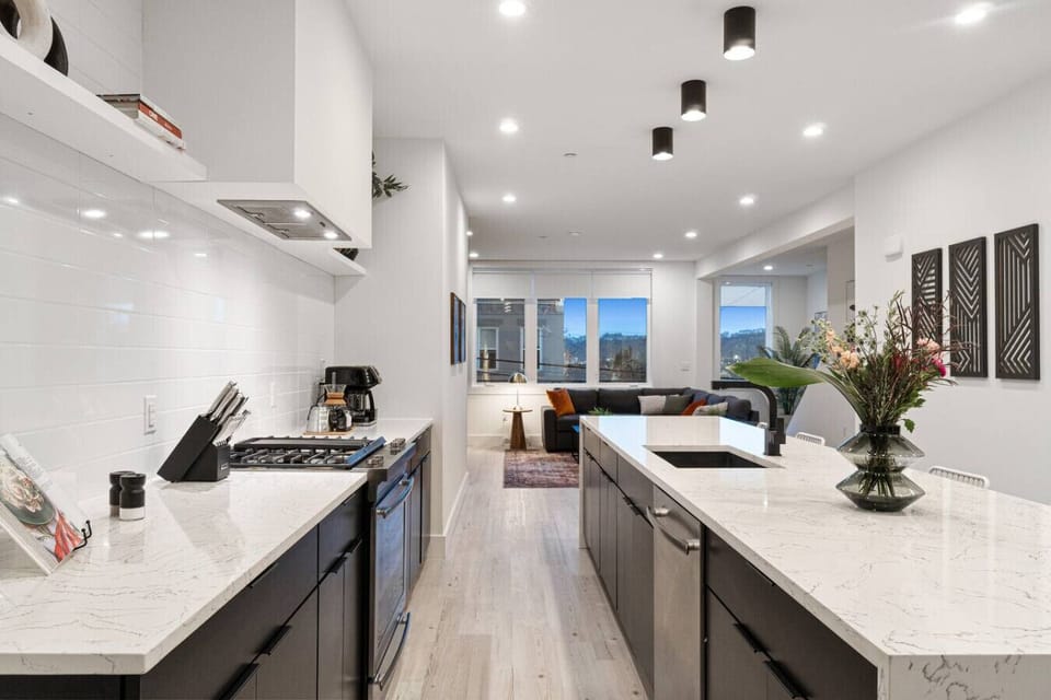 Sleek chef’s kitchen with premium appliances & ample prep space.