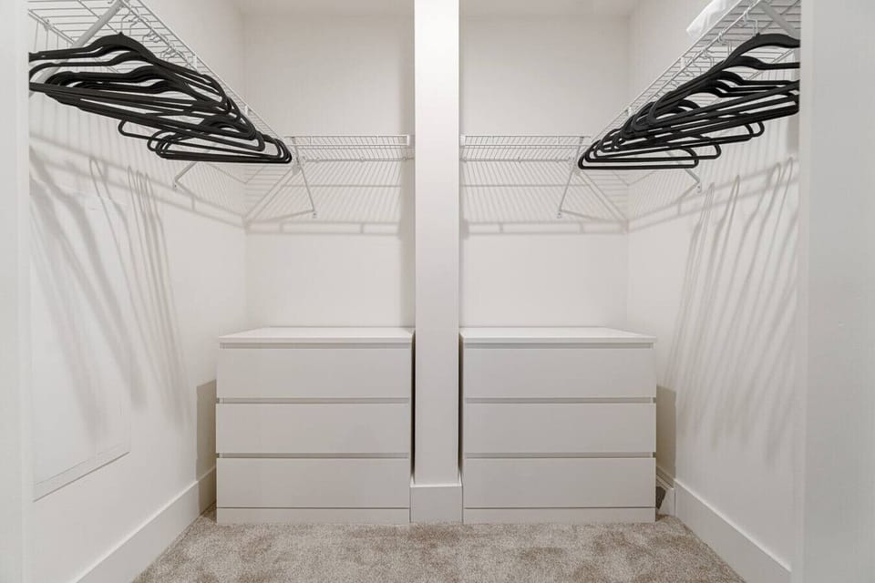 Spacious walk-in closet with built-in storage and hang space.