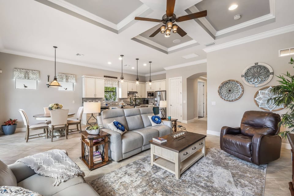 This elegant home is decorated in a soothing neutral palette, highlighted with coffered ceilings and furnished in family-friendly furnishings.
