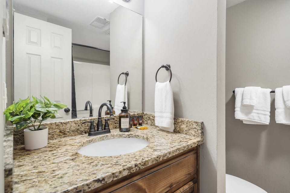 Wash up in the hall bath, showcasing a single vanity & shower/tub combo