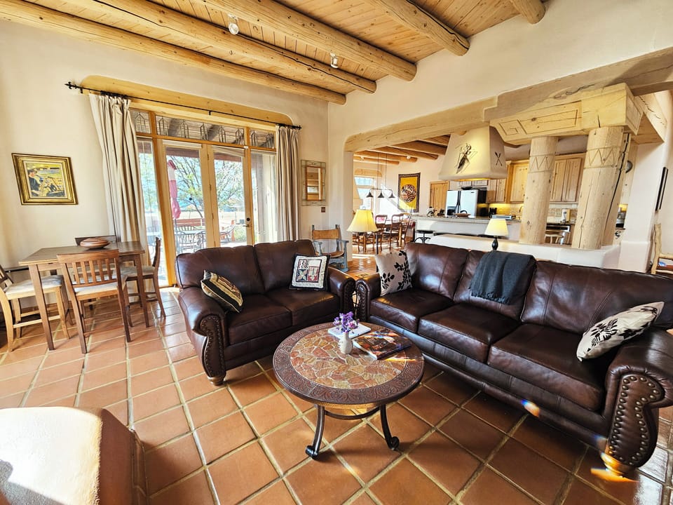 Large living area with kitchen in the background