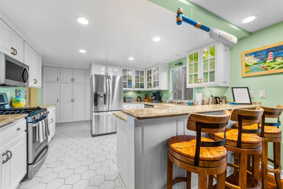 Kitchen is equipped with stainless steel appliances and cooking basics.