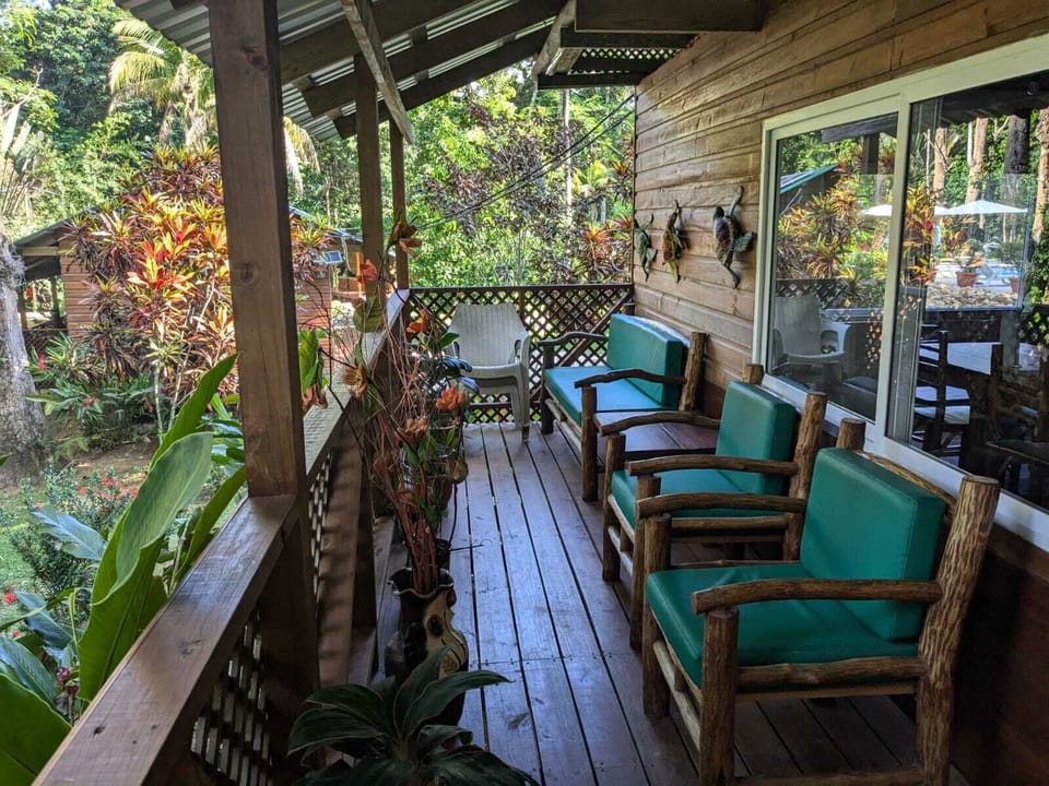 The front porch overlooks the water, offering a perfect spot to relax, enjoy the view, watch local birdlife, or spot turtles gliding through the water below.