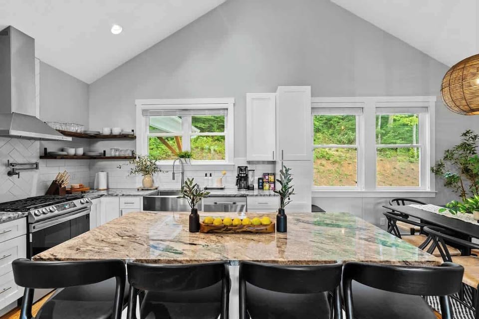Our kitchen is designed for both cooking and gathering, featuring a spacious island, modern appliances, and abundant natural light.  Enjoy glimpses of the mountains while preparing meals in this stylish and functional space.