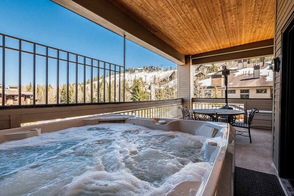 Private covered deck with hot tub and mountain views