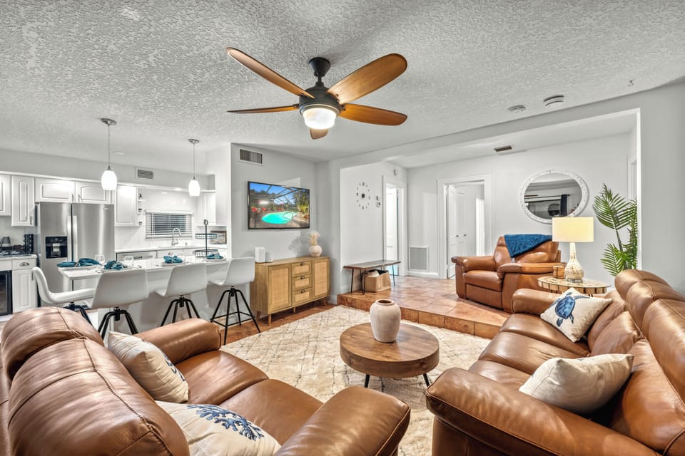 Open living area with comfortable seating and kitchen access.