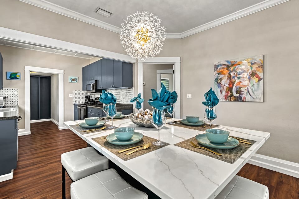 Cook together in the retro‑modern kitchen while light pours through windows, blending historic character and fresh style.