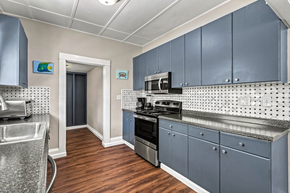 Cook and connect in a bright, open kitchen featuring sleek countertops and plenty of space to prepare your favorite meals.