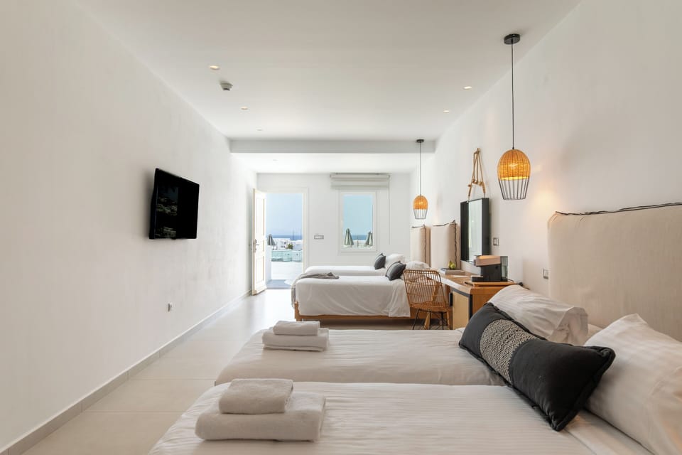 Deluxe Quadruple Room, 1 Bedroom, Sea View | Premium bedding, in-room safe, desk, laptop workspace