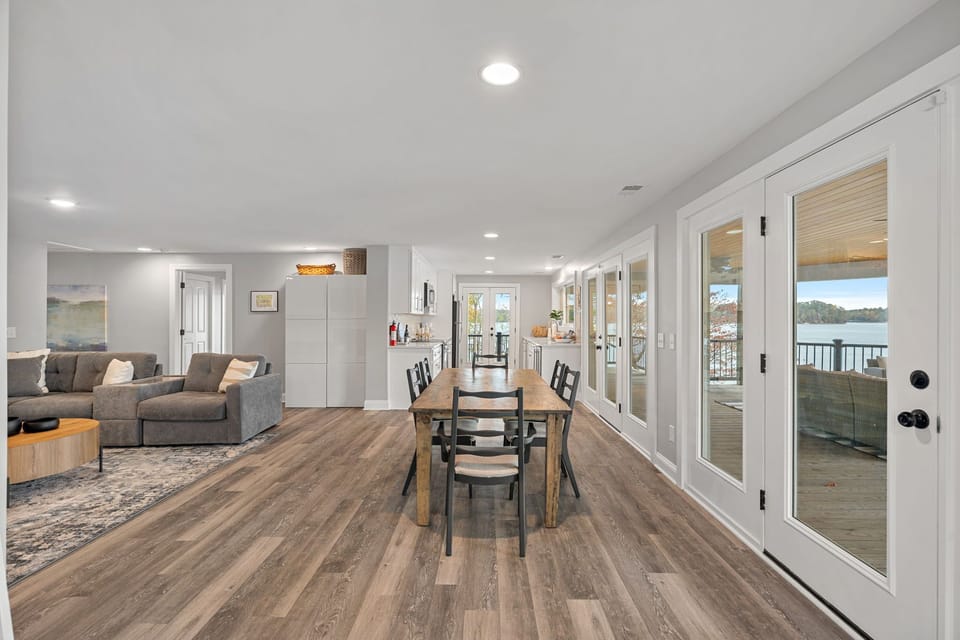 Open concept main level dining seating for 6, deck access & living room area.