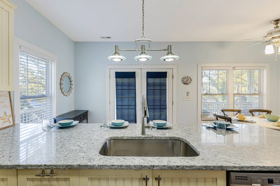Spacious kitchen counter for meal preparation and extra seating.