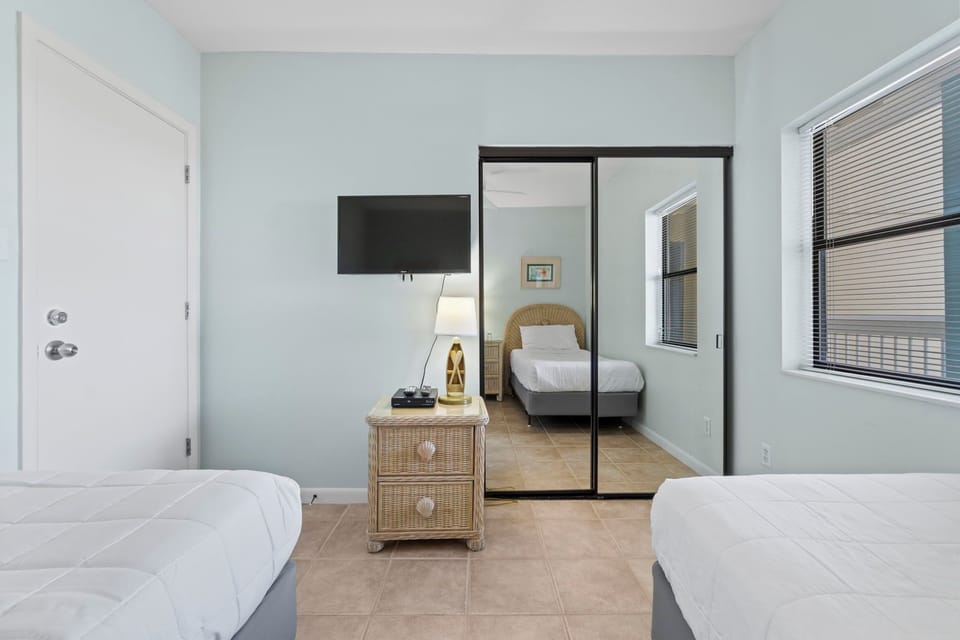 Third bedroom features two twin-size beds and TV