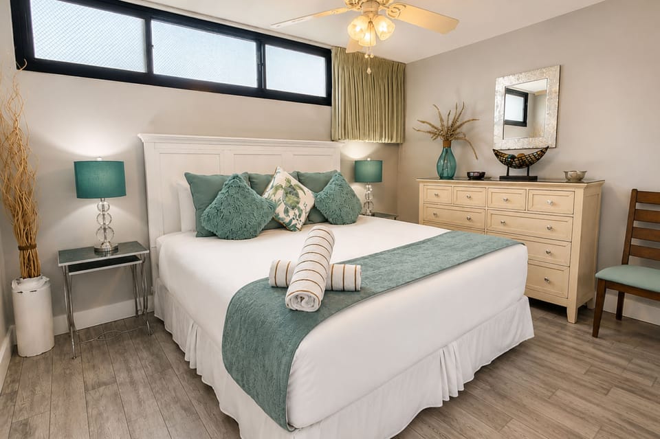Primary bedroom with a King bed, ceiling fan, and coastal accents for a peaceful night’s sleep.
