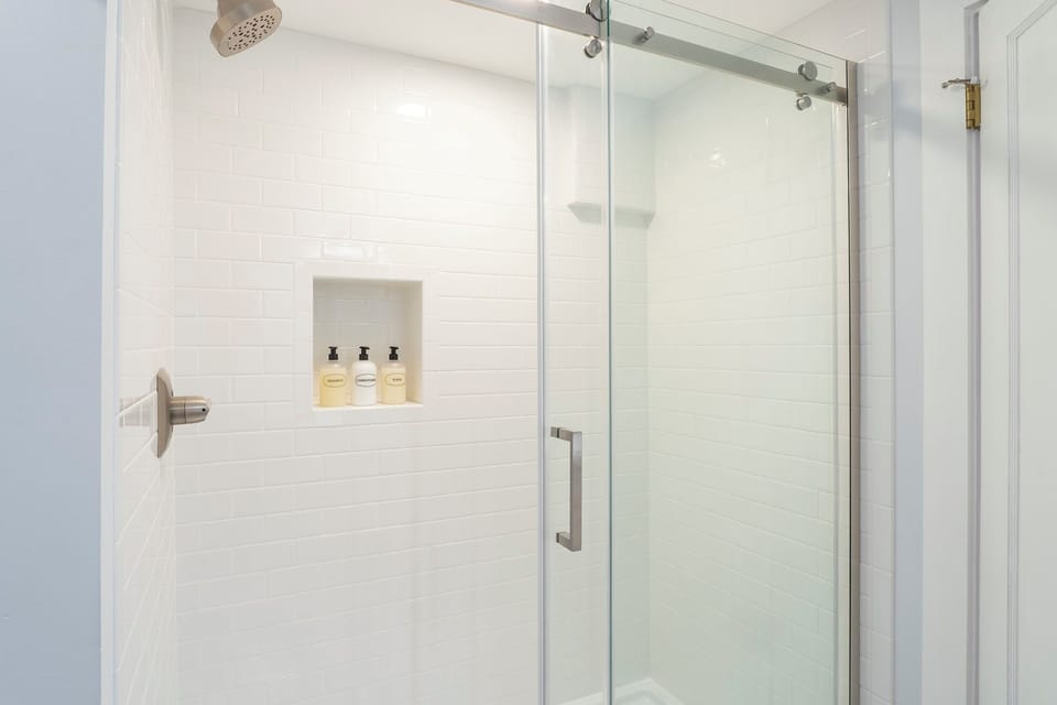 Shampoo, conditioner and body wash are found in the spacious shower enclosure