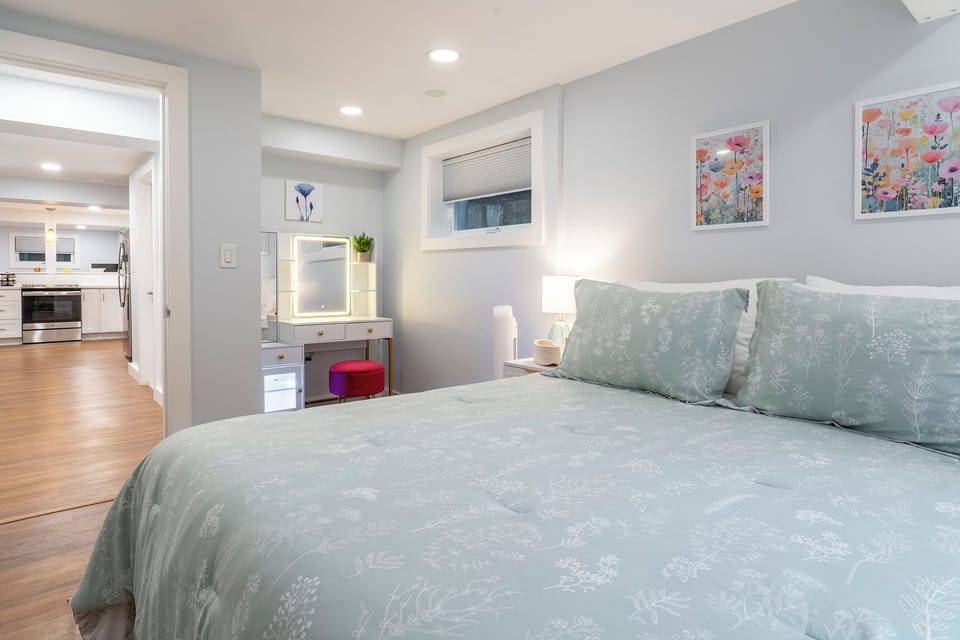 First bedroom is stylish and comfy with memory foam Queen bed and vanity desk with lighted mirror