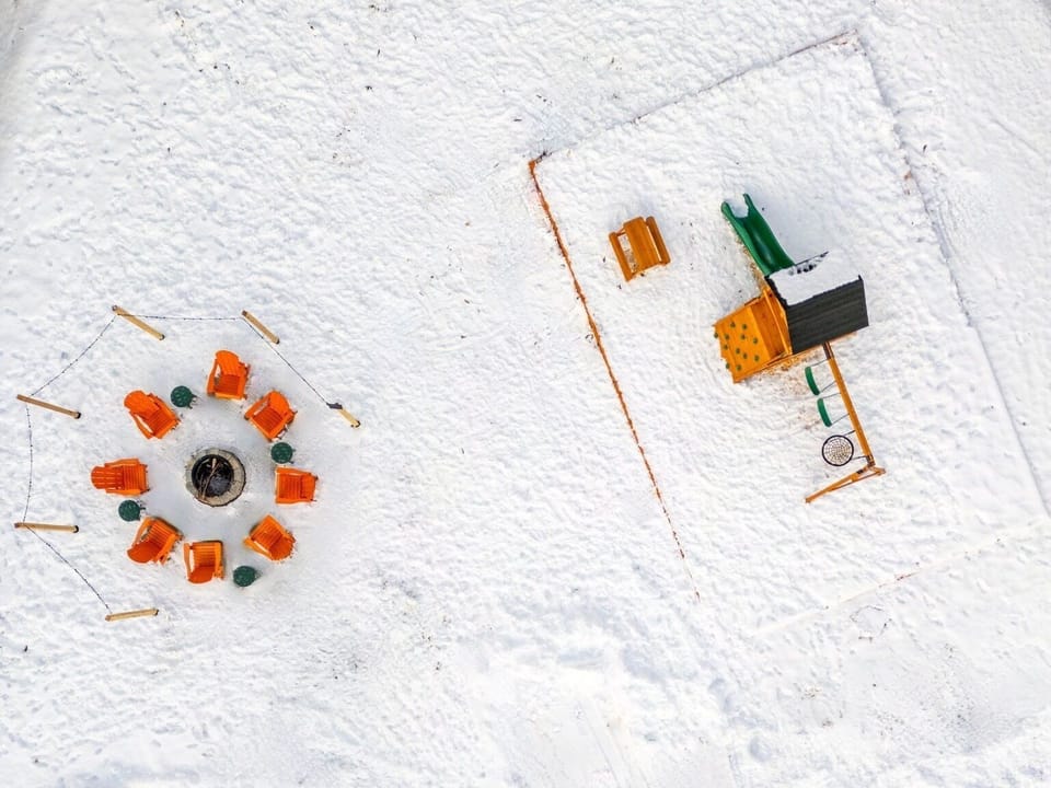 Gather around the snowy firepit while the kids enjoy the playground!