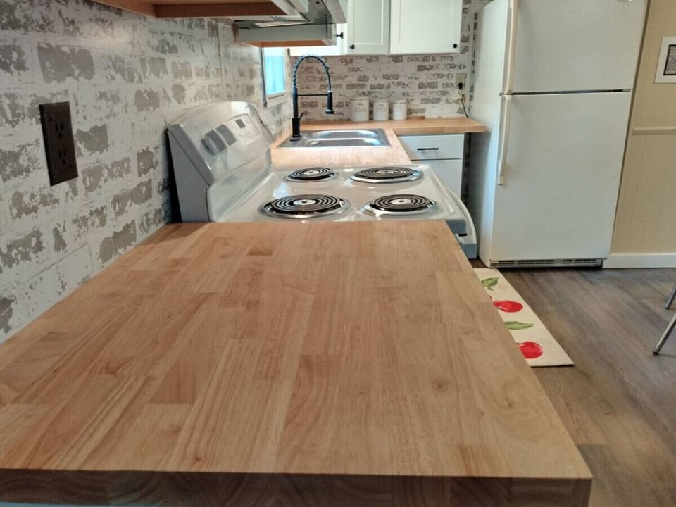 Cook & connect in the fully-stocked kitchen with a spacious counter and 2-basin sink, making meal prep and clean up a breeze!