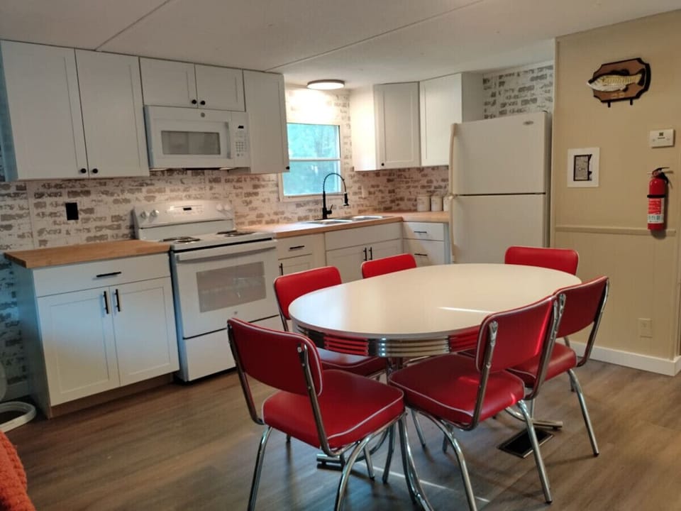 Cook & connect in the fully-stocked kitchen with a spacious retro dining table for 6. Extra chairs stowed away for those big family meals