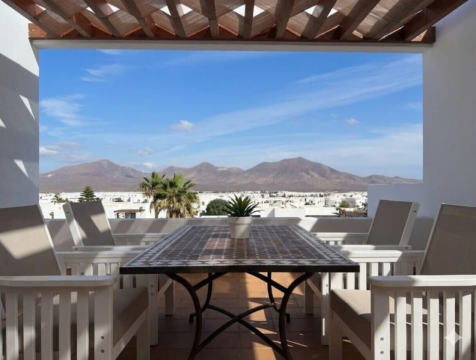 Upper terrace with table and mountain views.
