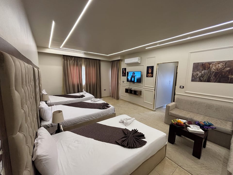 Triple Room, Garden View | Desk, laptop workspace, soundproofing, iron/ironing board