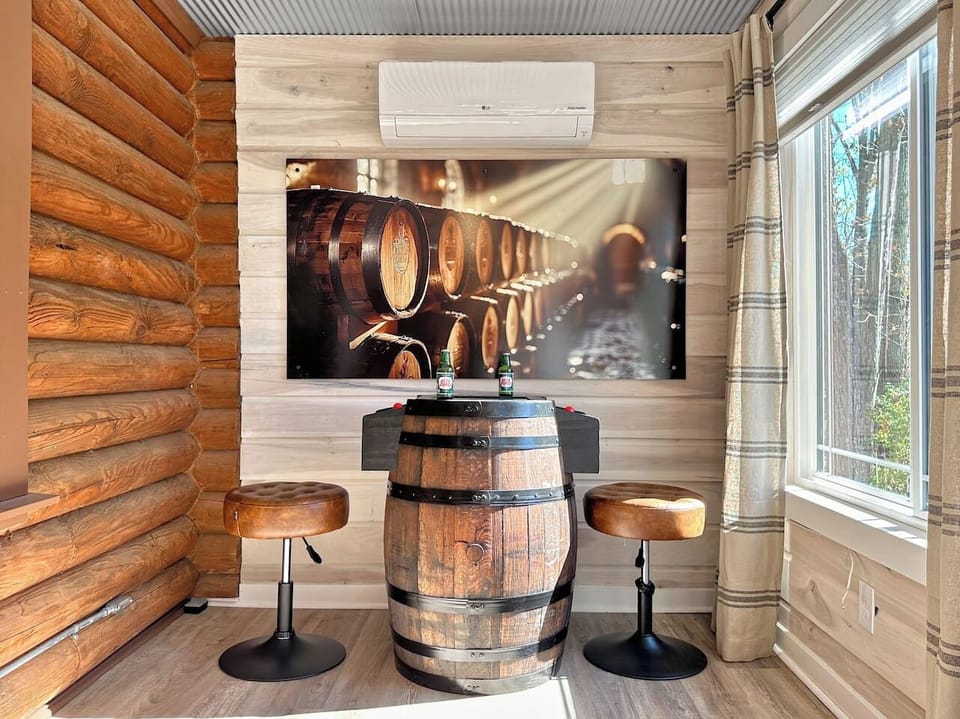 Right off the dining area is the sun room / game room. At one end you have a bourbon barrel 2-seat arcade.