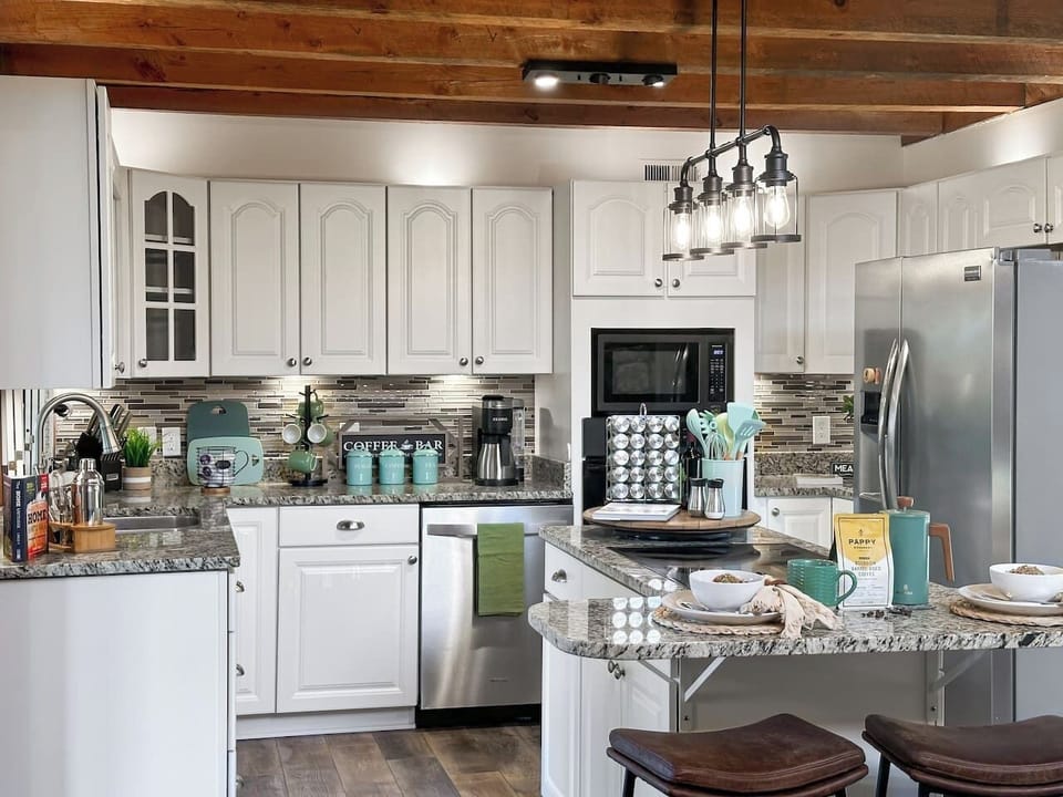 The dining area opens right up to the kitchen, fully stocked with everything you need to prepare a meal.