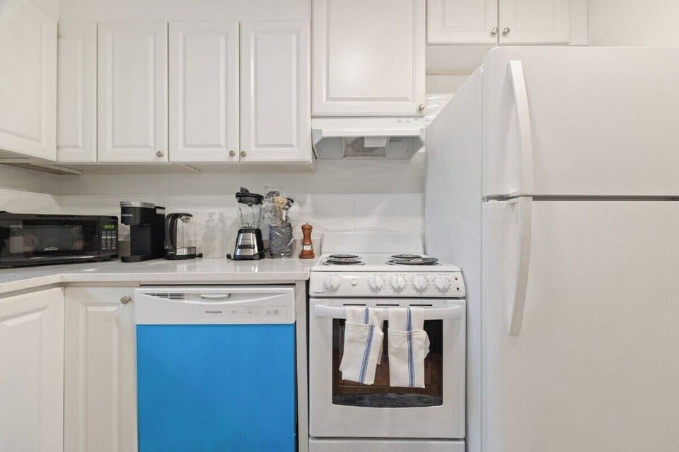 Full kitchen with refrigerator and range