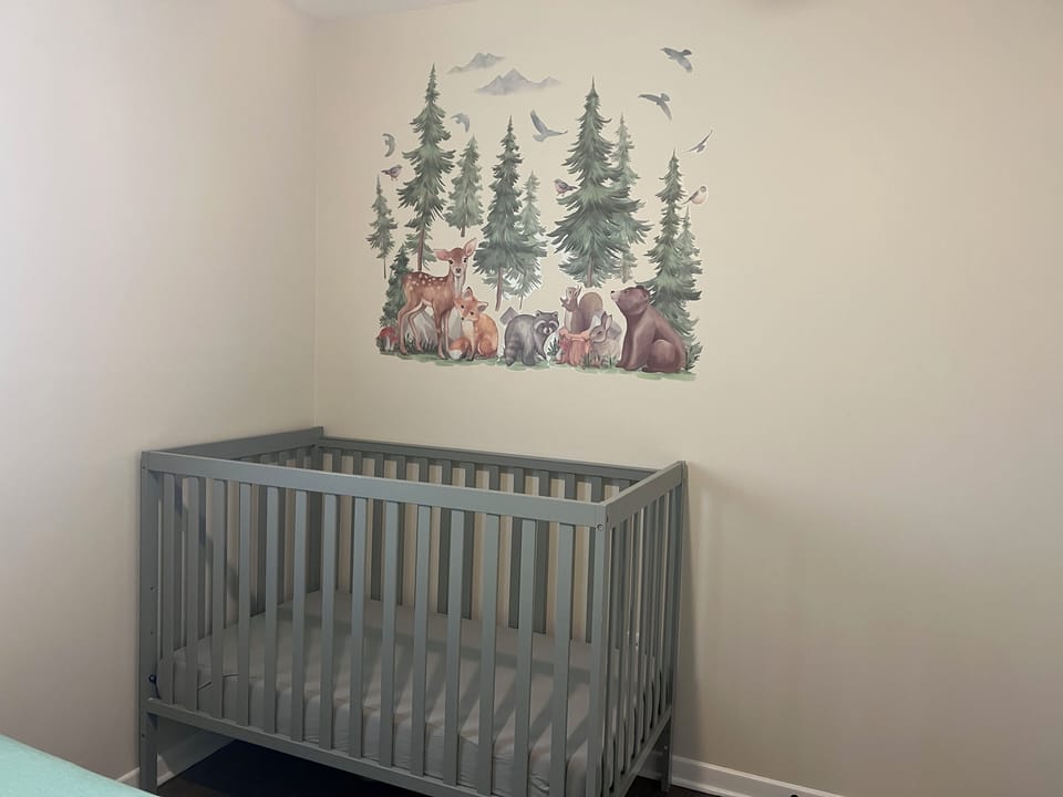 Crib in a room with a queen bed