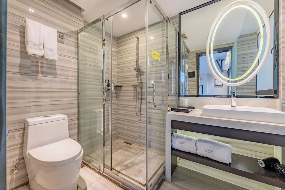 Shower, hair dryer, slippers, towels