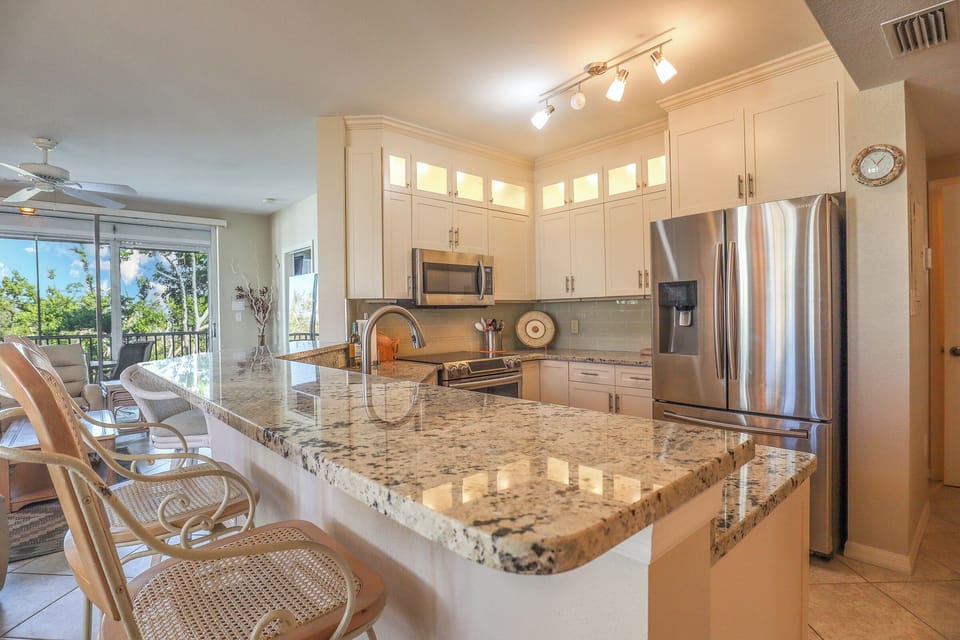 Large Fully Equipped Kitchen features a breakfast bar for four