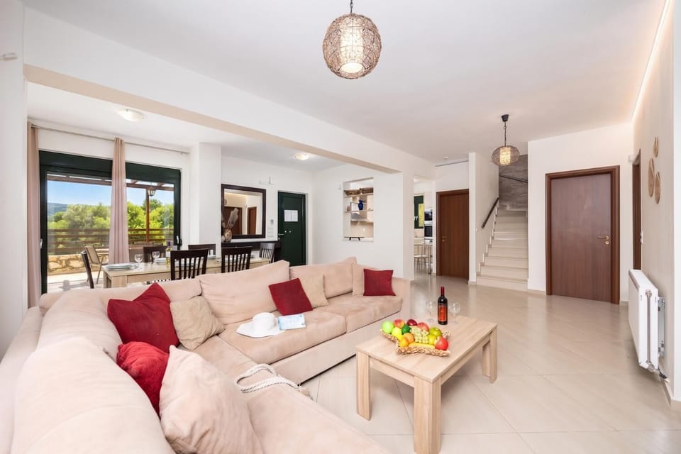 Open-plan living room with sofa, dining area, kitchen, ornamental fireplace, A/C, WiFi internet, satellite TV, and sea views