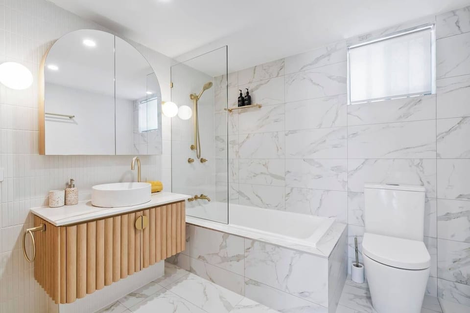 Indulge in the stylish main bathroom, boasting a bathtub, premium fittings, and a spa-like ambiance.