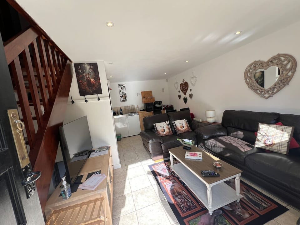 Showing the kitchen area at the back of the living area.