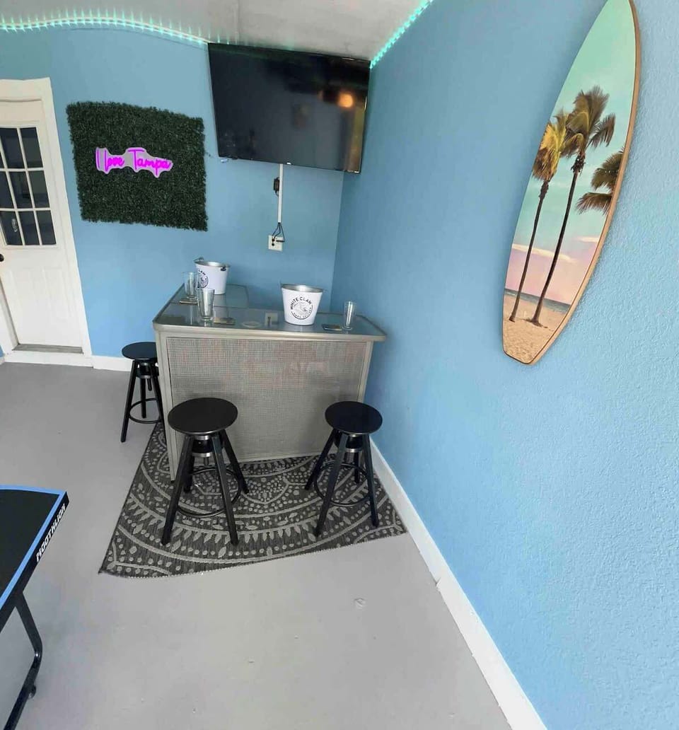 Ping pong, darts, and drinks, oh my! The garage game room is your go-to for fun and relaxation.  #GameRoomFun #TampaLiving #UnwindAndPlay