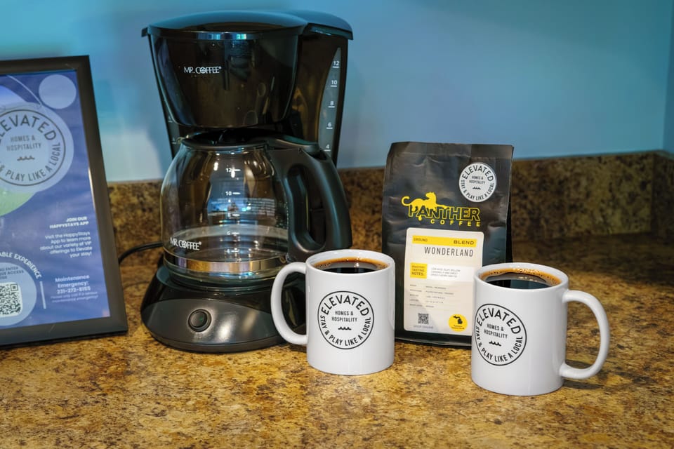Coffee station with fresh local coffee, branded mugs, and everything guests need to start the morning right.