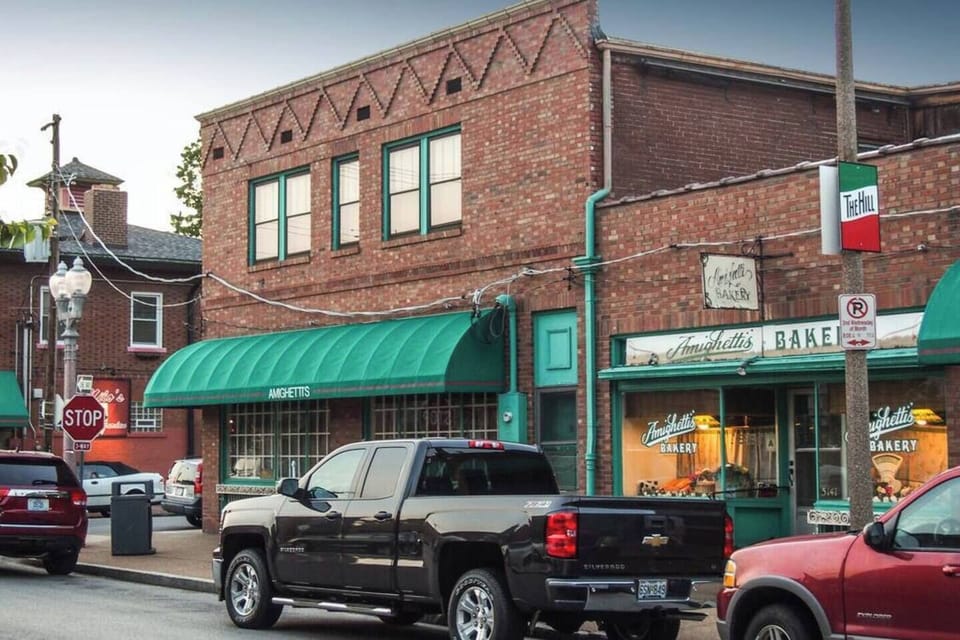 This neighborhood streetscape shows Amighetti's Bakery and The Hill's characteristic brick storefronts.