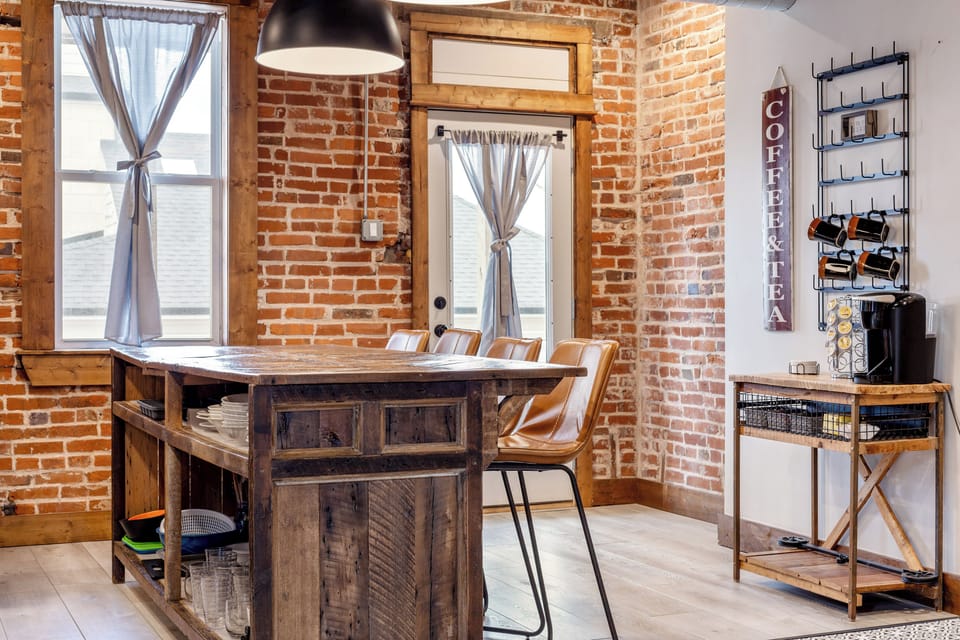 The rustic dining bar provides four seats beside a dedicated coffee and tea station.