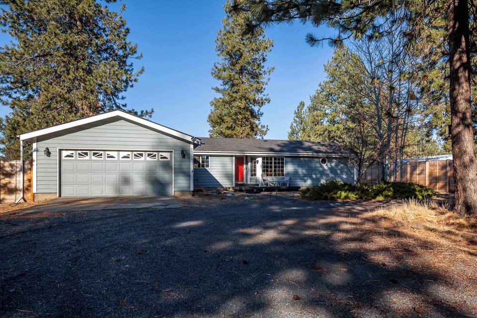 The entrance and garage to the home. There is also parking for multiple vehicles and/or larger vehicles. 