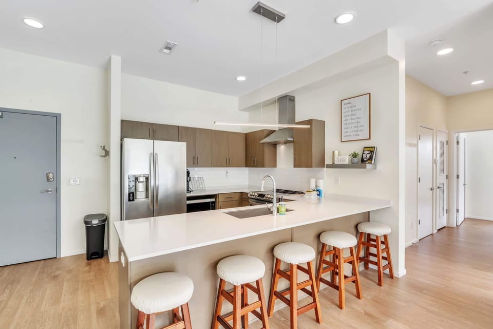 The sleek, open kitchen offers ample space & every home comfort