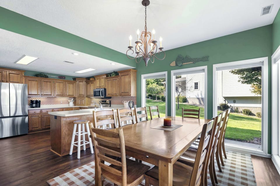 Dining room with table and seating for 10 and additional counter seating  for 4