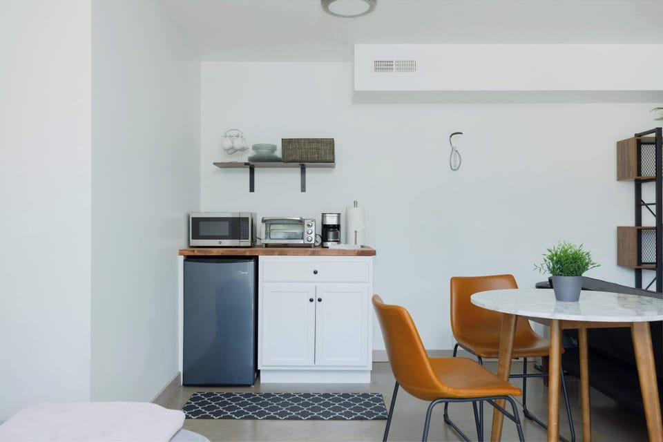 Kitchenette includes microwave, toaster oven, coffee machine, and other necessities for a meal. 