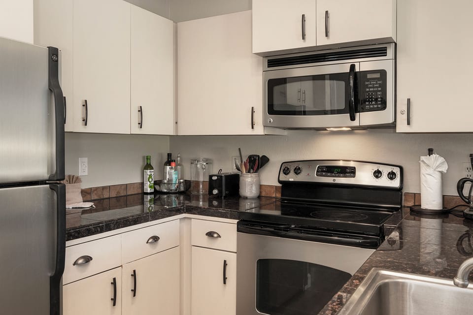 Your fully equipped kitchen awaits with sleek granite counters, stainless appliances, and everything you need to create memorable meals during your stay.